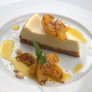 Baked ricotta cheesecake topped with char-grilled schnapps peaches